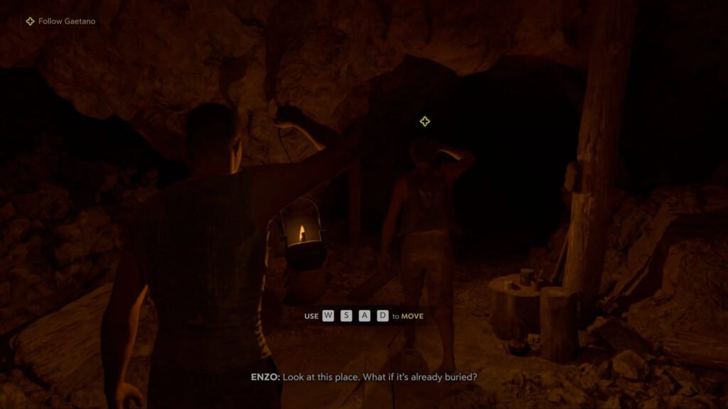 Two men holding lanterns inside dark cave tunnel