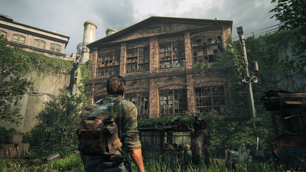 Joel in The Last of Us facing abandoned factory courtyard