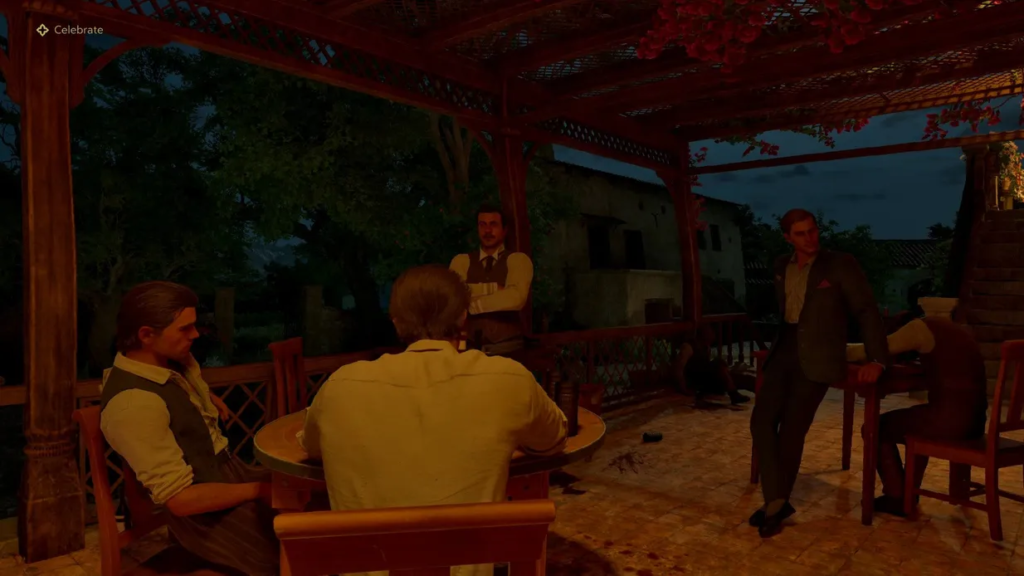 Men sitting and standing around table on patio
