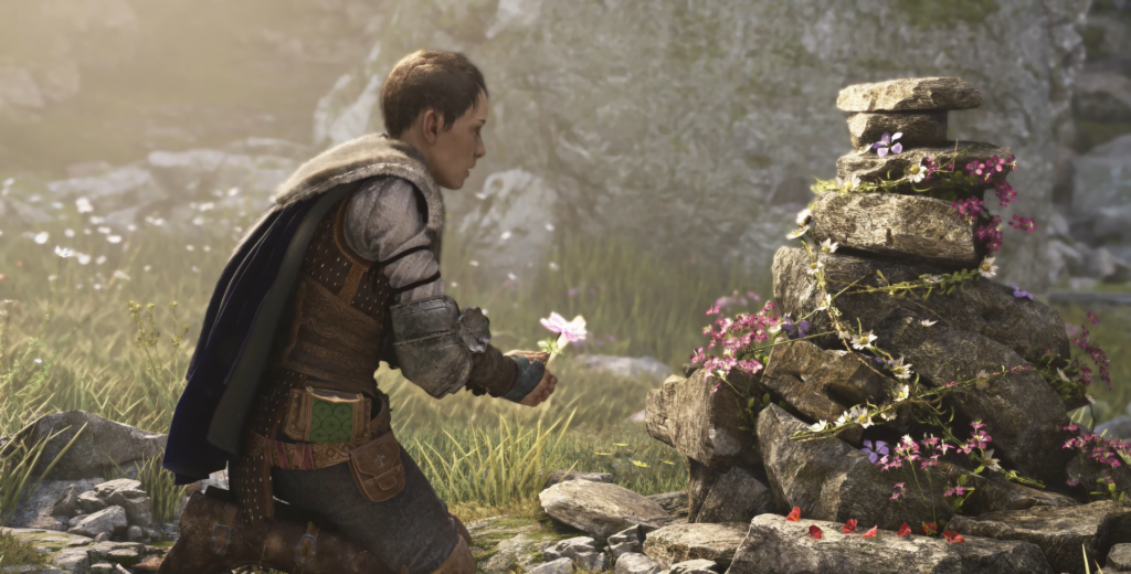 Man kneeling by flower-adorned stones.