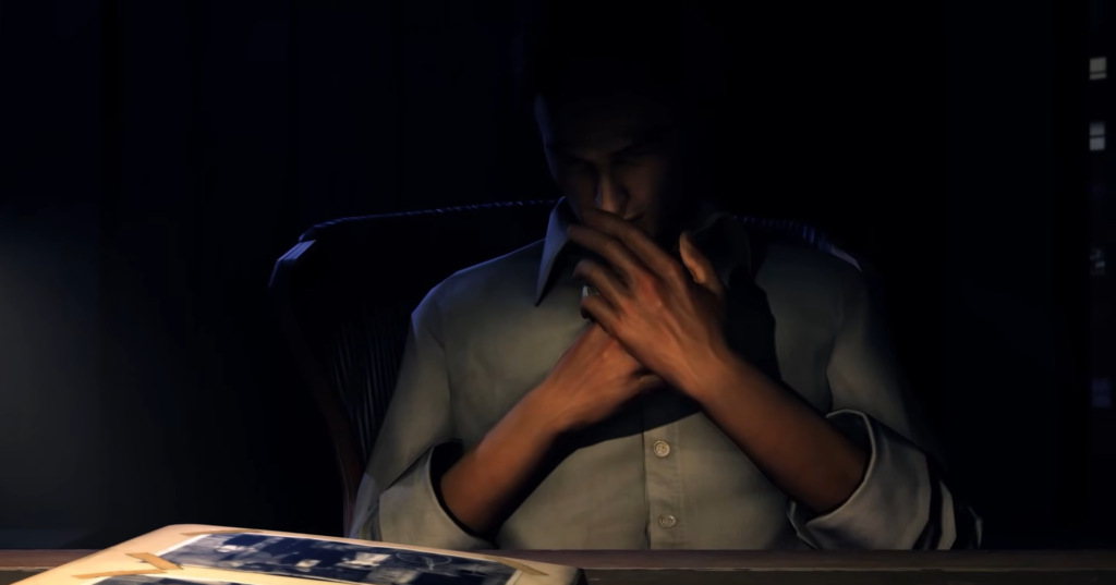 man in dark shirt examining photograph