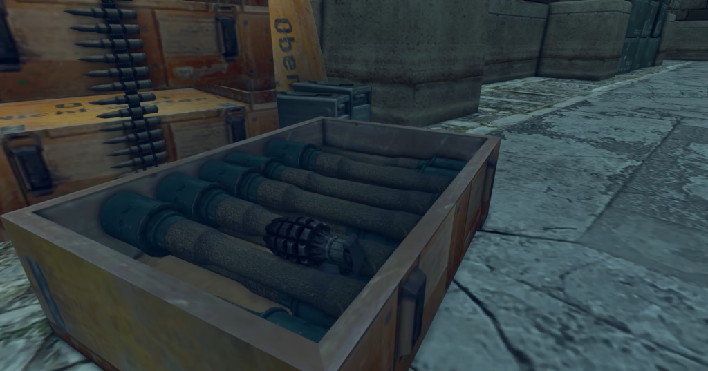 Grenade among cylindrical explosives in crate.