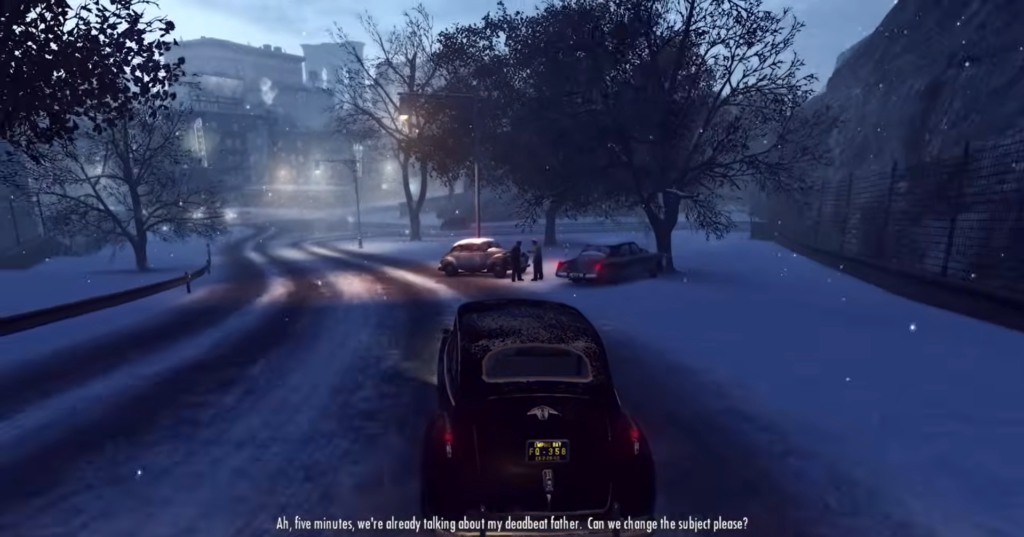 Vintage car driving snowy road scene.