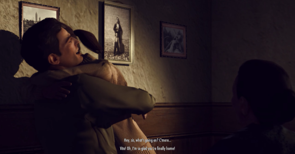 Man hugging woman, wall with photos.