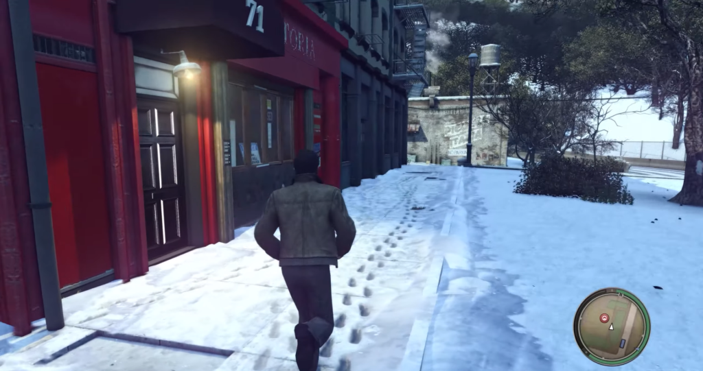 Man walking past red building, snow.