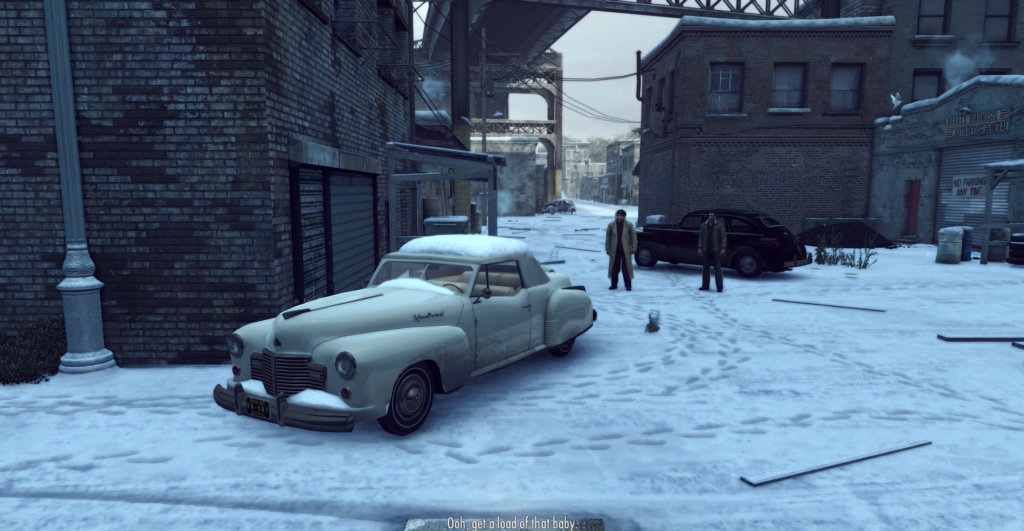 Snow-covered street with vintage cars.