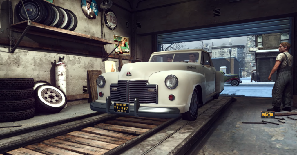 White classic car in garage setting.