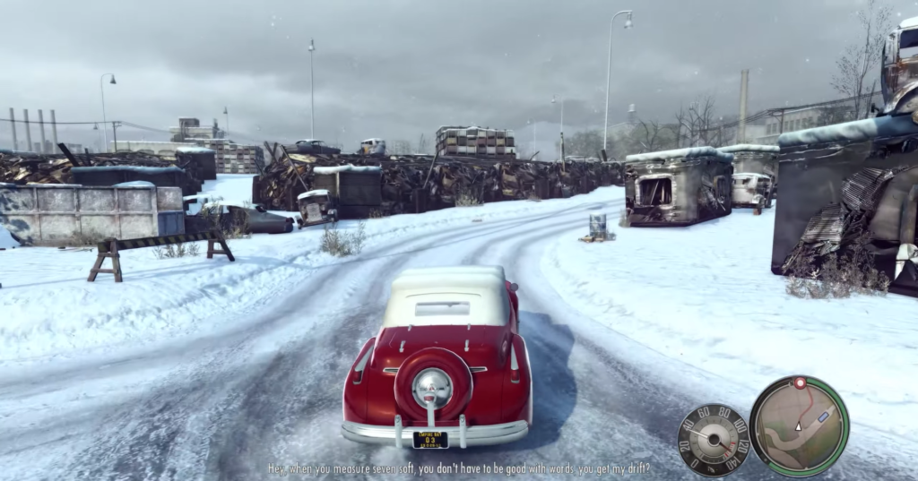 Red vintage car driving snowy road.