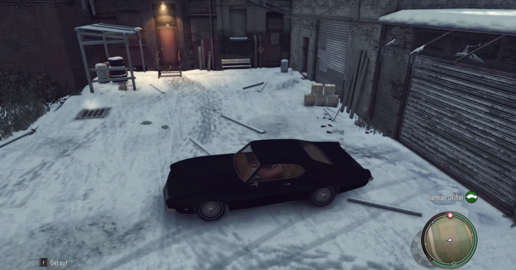 Black car parked on snowy street.