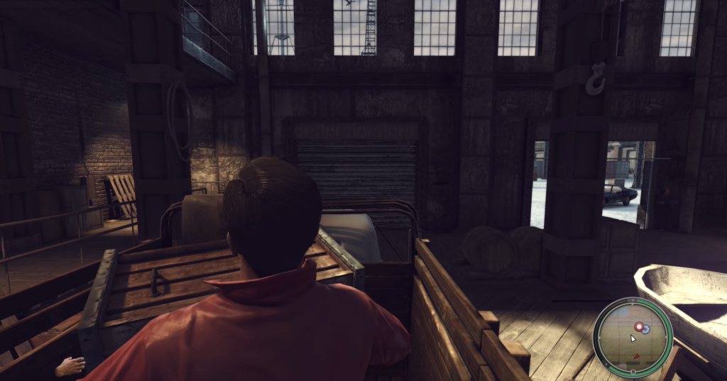 Man in red shirt inside warehouse.