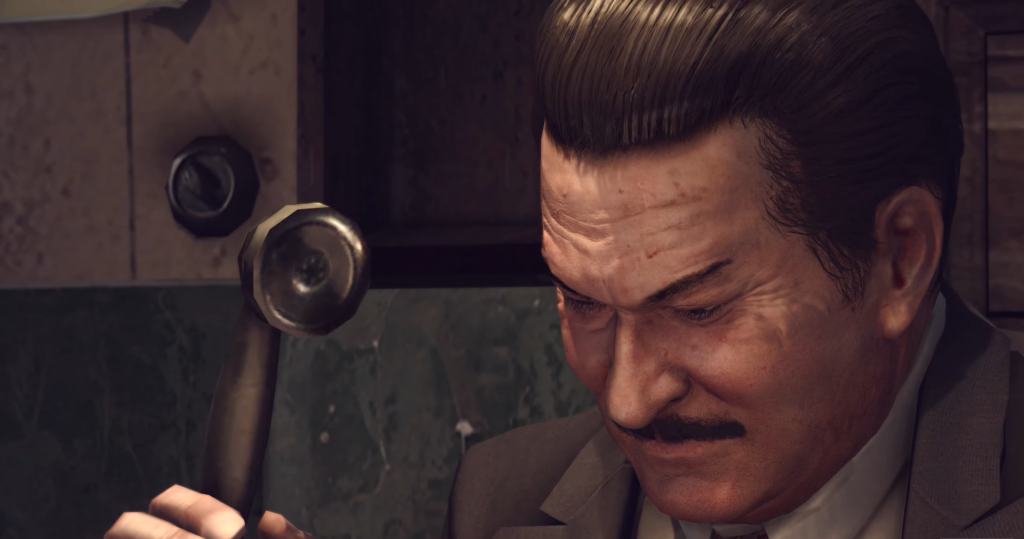 Man in suit holding telephone receiver.