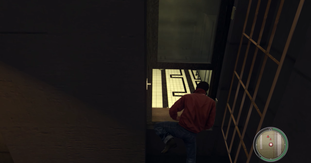 Man climbing through window, red jacket.