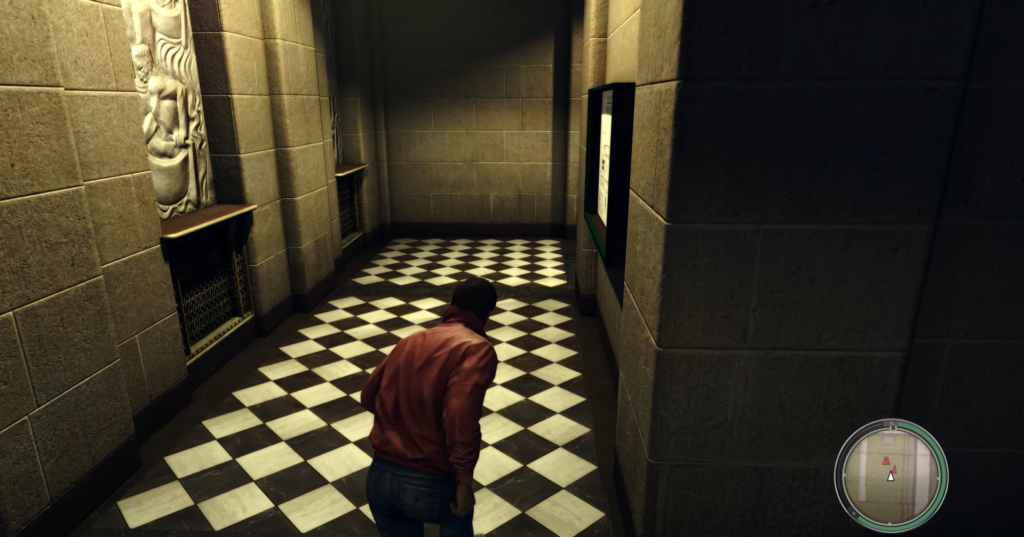 Man in red jacket walks hallway.