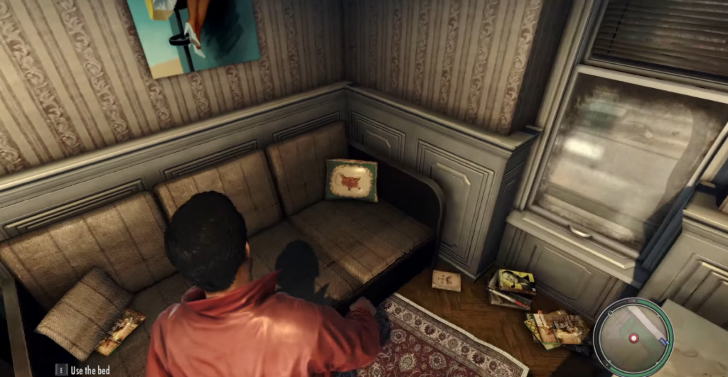 Man in red jacket near couch.