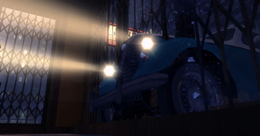 Blue vintage car illuminated by headlights.