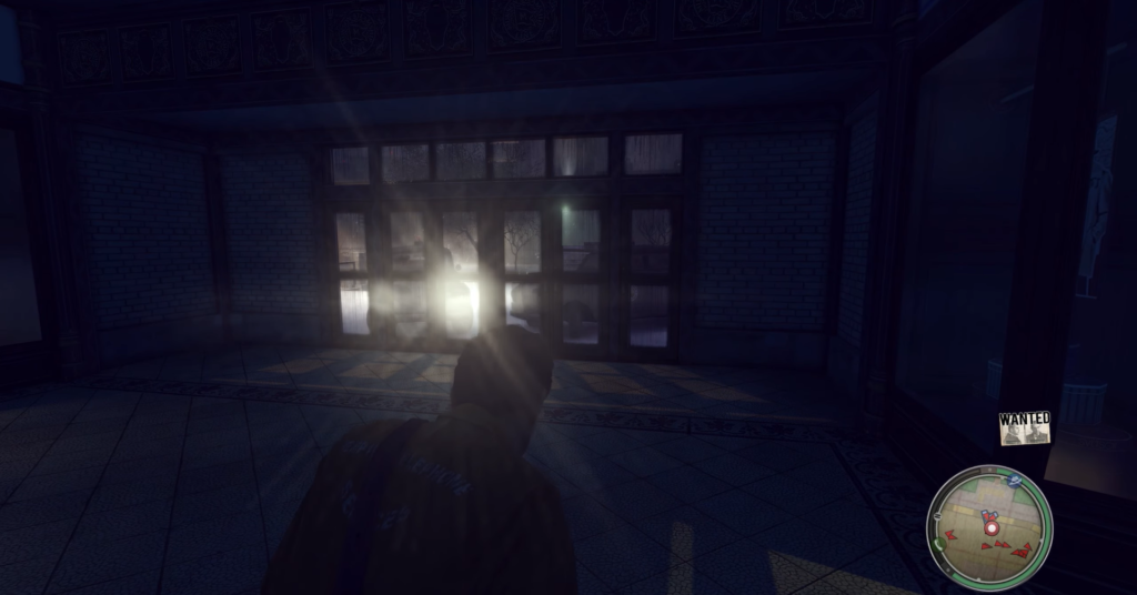 Man in jacket approaches illuminated doorway.