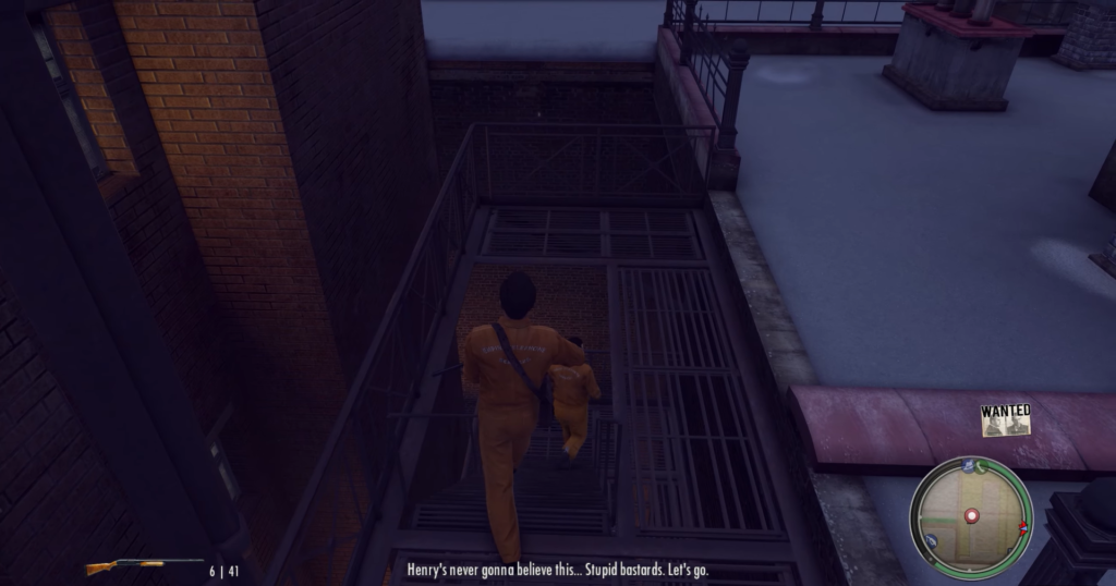 Man in orange jumpsuit on rooftop.