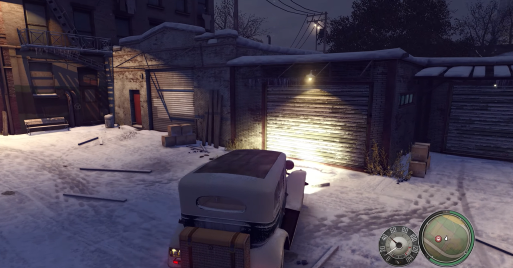 Vintage truck parked near snowy garage.