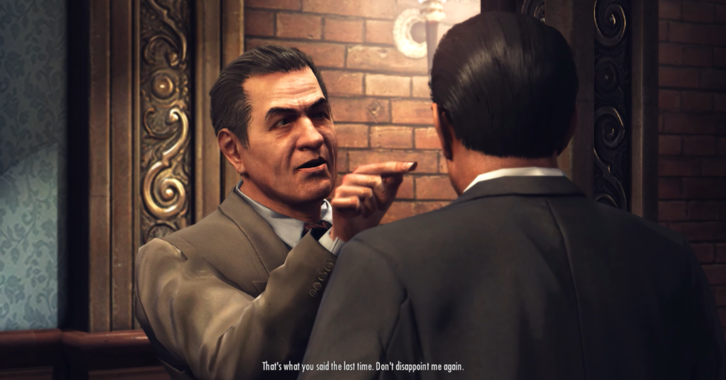 Man in suit points sternly, brick wall.