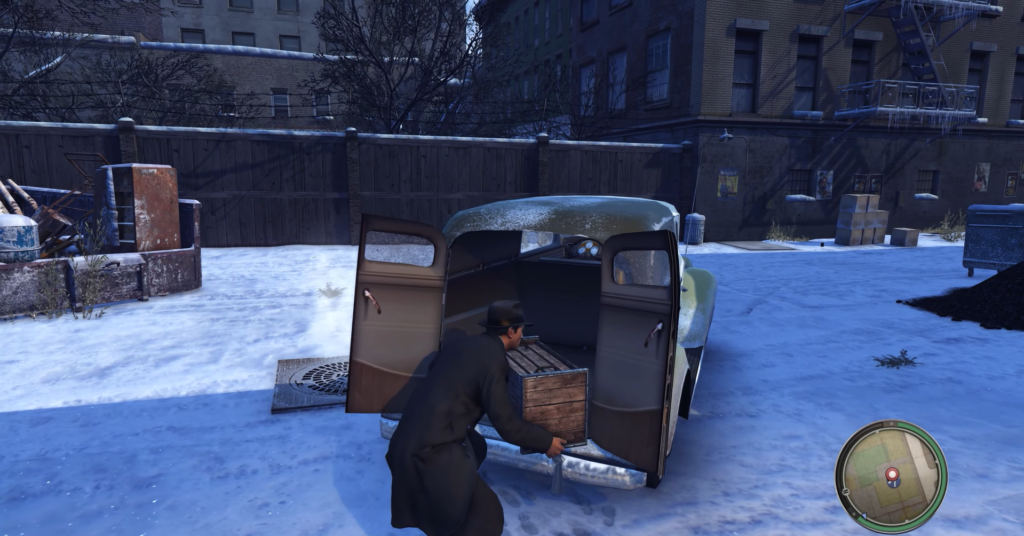 Man in black coat loading vintage car.