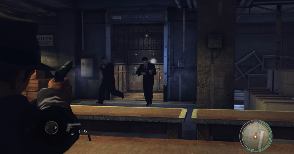 Gunman aiming at fleeing men indoors.