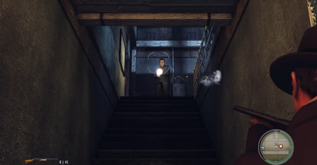 Man aiming gun down staircase.