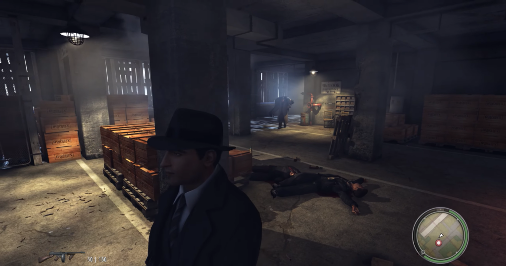 Man in suit stands near bodies.