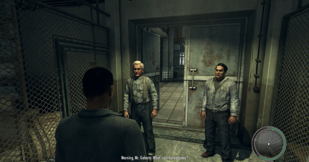 Two men in prison uniforms talking.