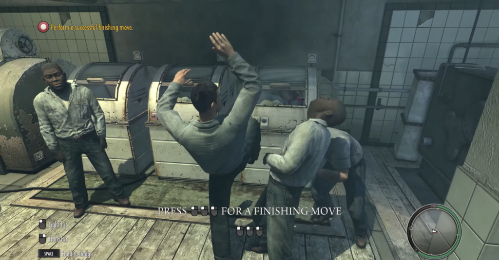 Man kicking another in industrial setting.