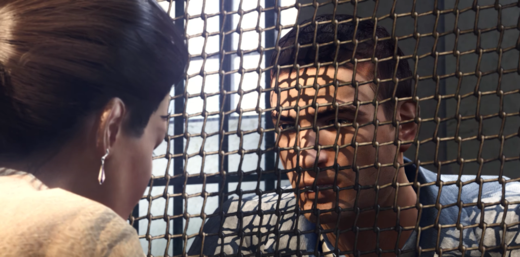 Man behind mesh screen, woman listening.