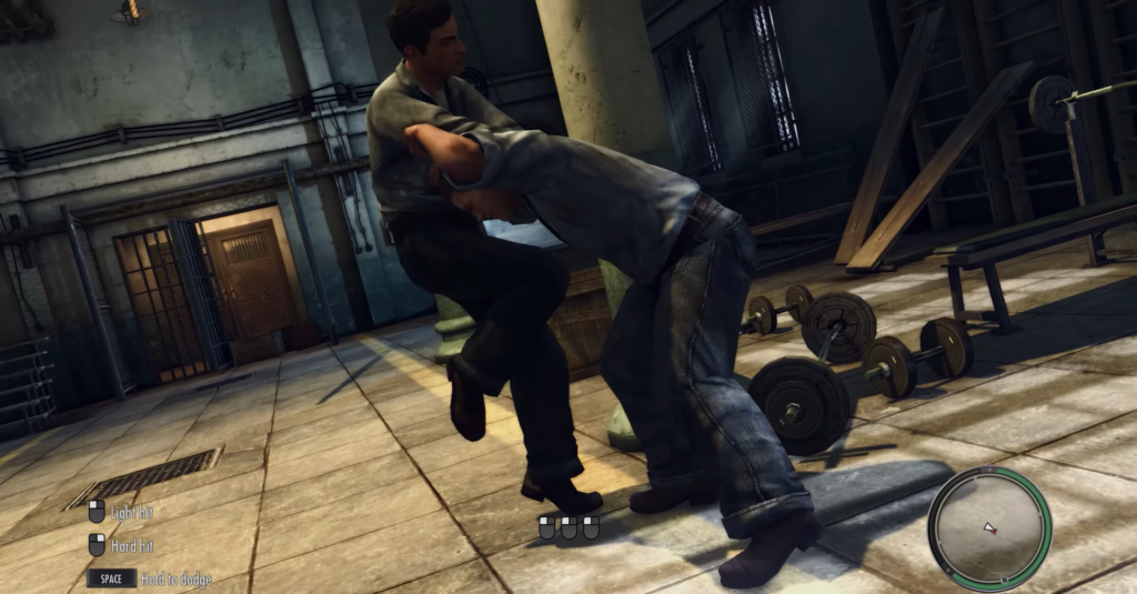 Two men fighting in gym setting.