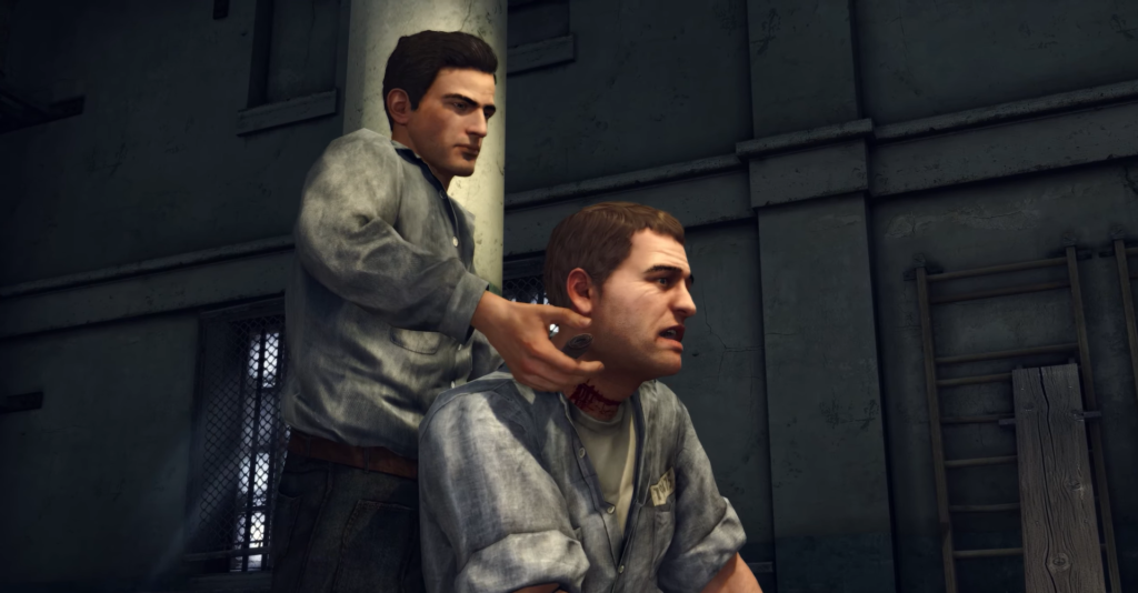 Man holding knife behind seated man.