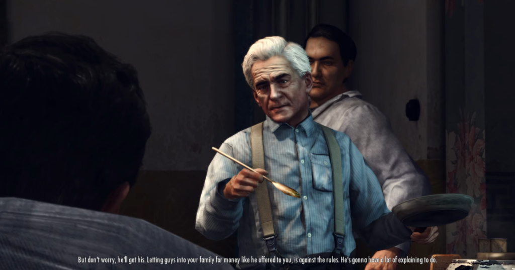 Man gesturing with paintbrush, serious expression.