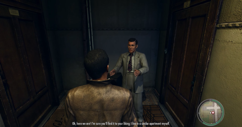 Man in suit talks to another.