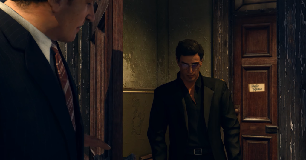 Two men in suits, dimly lit.