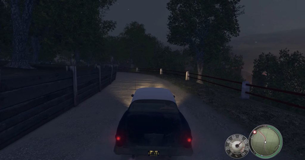 Classic car driving on dirt road.