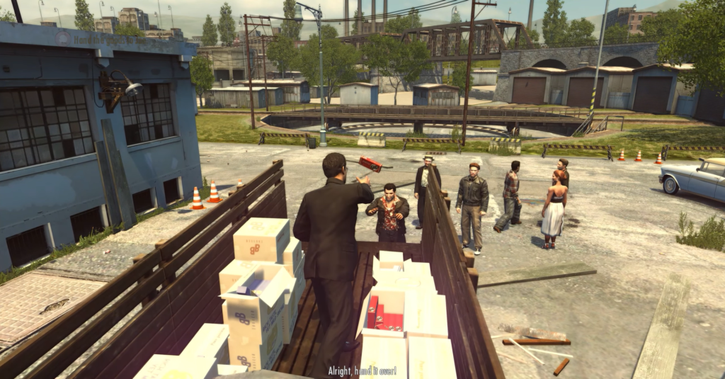 Man in suit gestures at crowd.