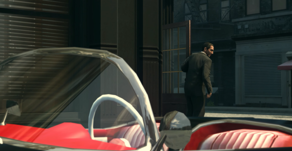 Man in suit exits building, vintage car.
