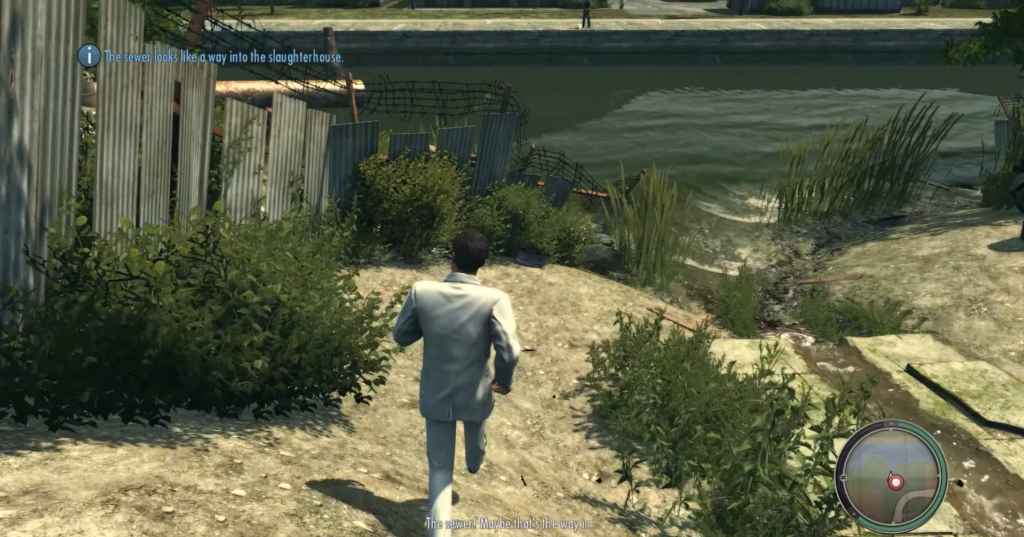 Man in white suit walking riverbank.