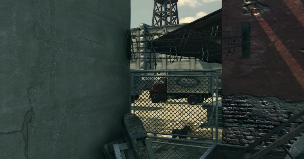 Red truck parked near barbed wire.