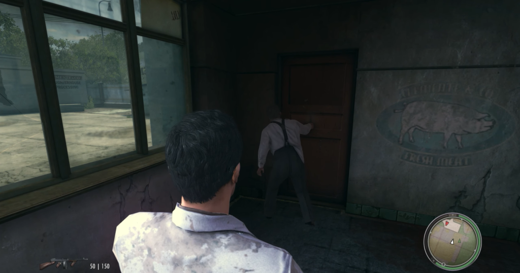 Man in suit knocking on door.