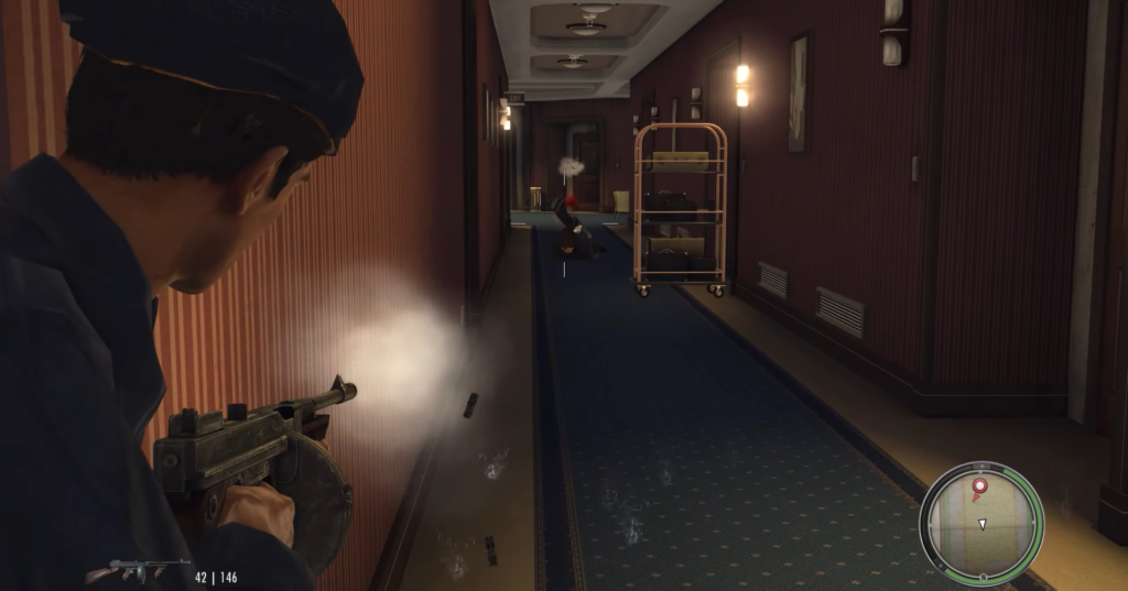 man shooting gun down hotel hallway