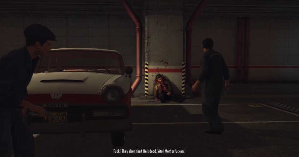 Man crouching, bloodied, near car.