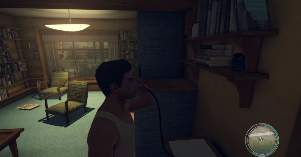 Man in tank top using rotary phone.