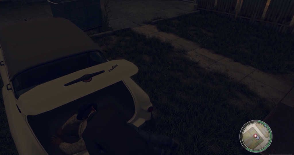 Man loading body into white trunk.