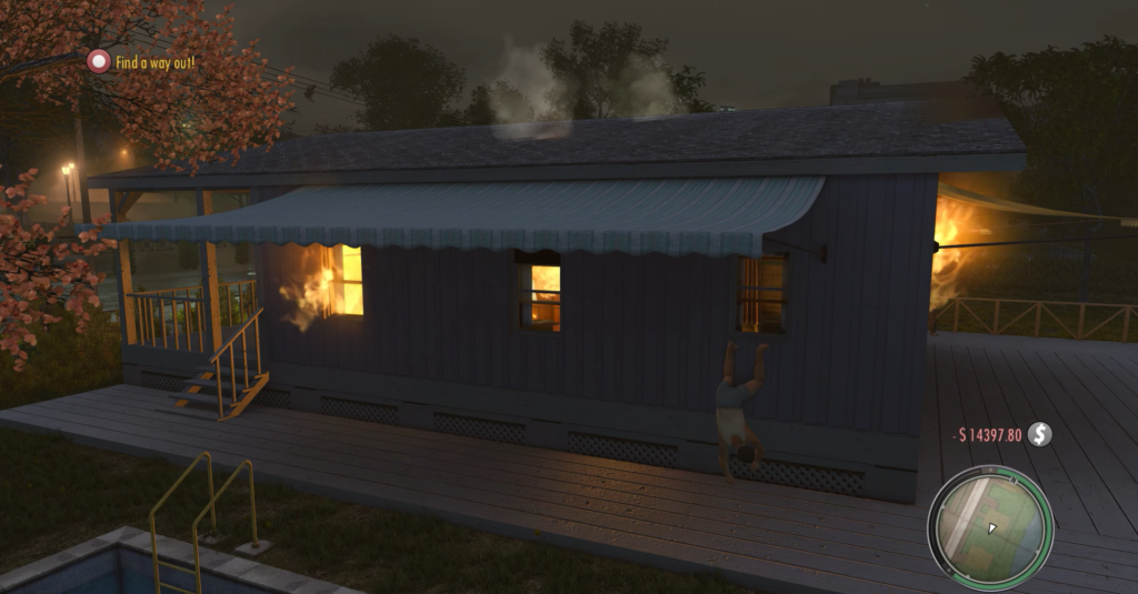 Man hanging from burning blue house.