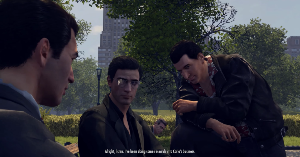 Three men discussing in park setting.