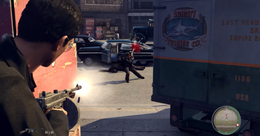 Man shooting from behind red wall.