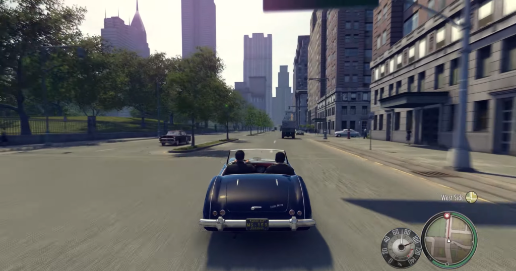 Black convertible driving city street.