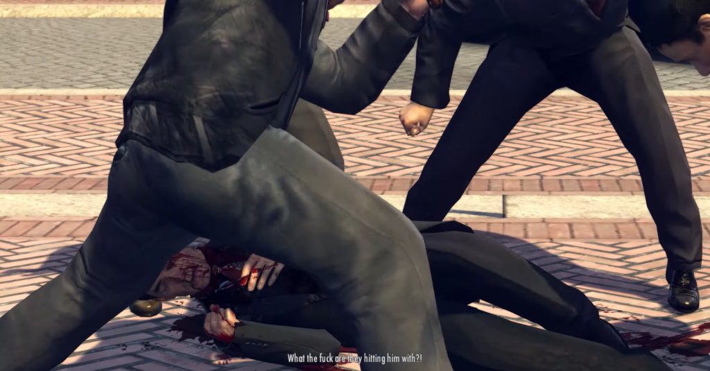 Two men attacking bloodied figure on ground.